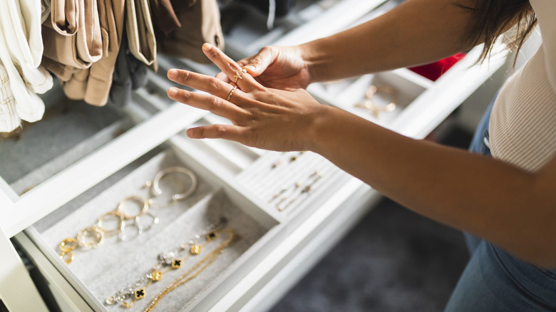 putting on ring over jewelry tray