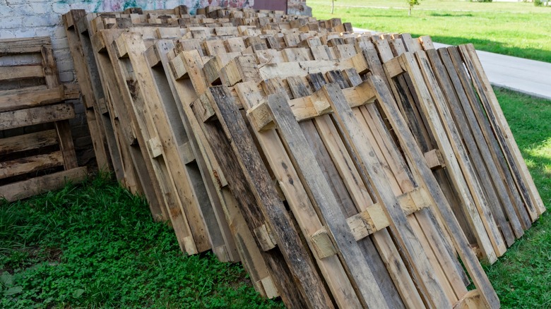 free pallets stacked in grass