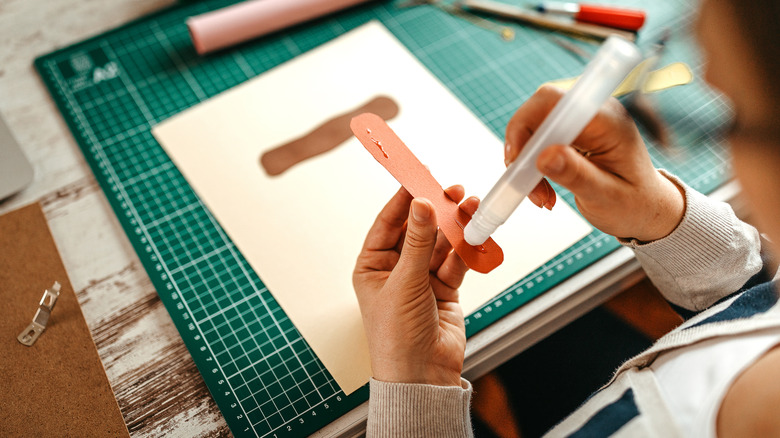 Person working with craft sticks.