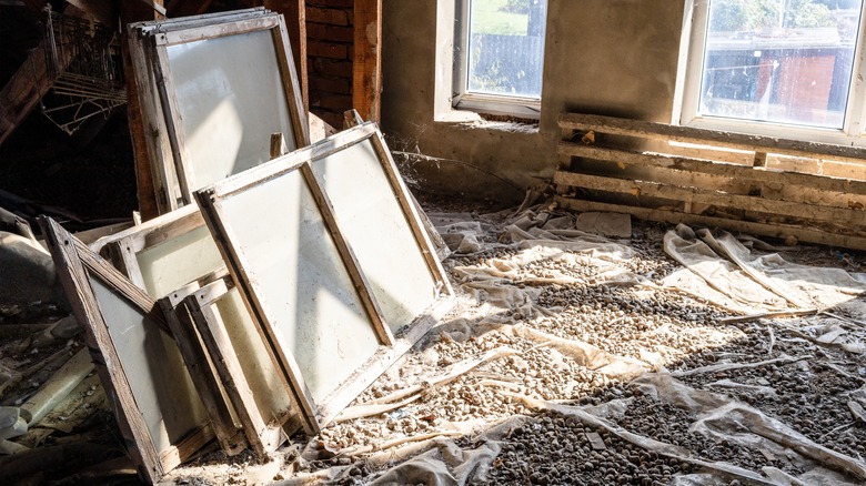 Old dusty windows stored in the attic of a house