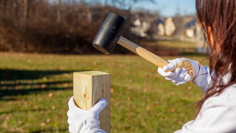 woman installing fence