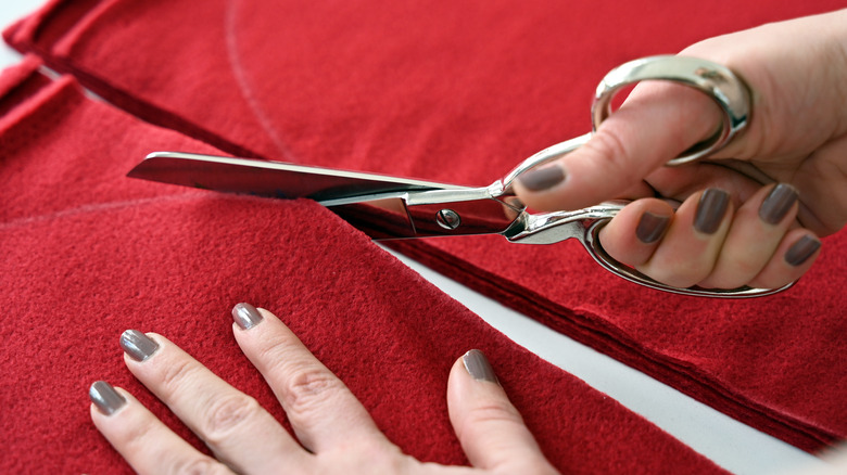 woman cutting red fabric