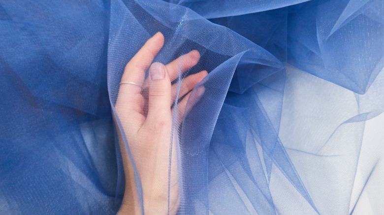 hand in blue tulle