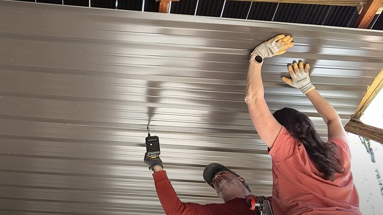 people attaching ceiling under deck