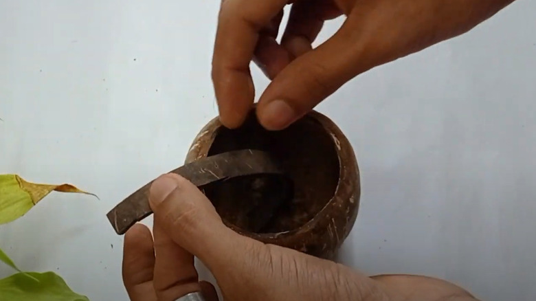 person gluing coconut pieces