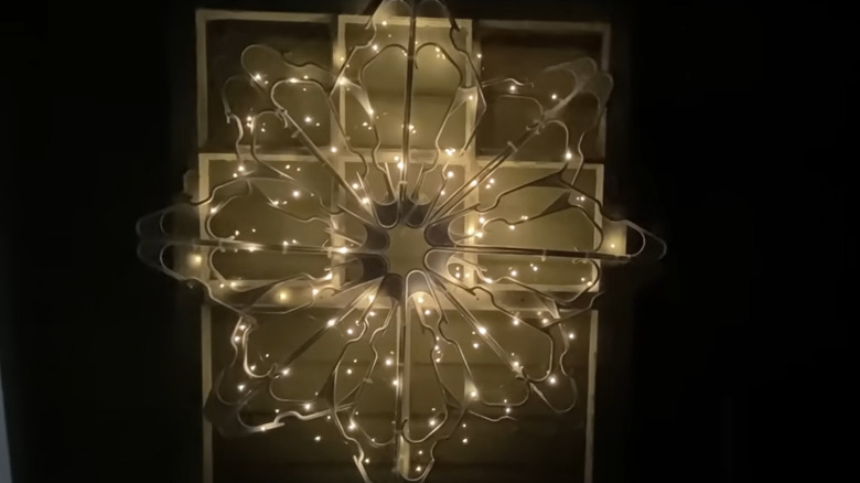 illuminated coat hanger snowflake outdoors after dark