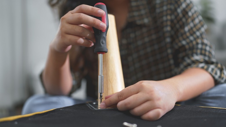 person removing furniture leg