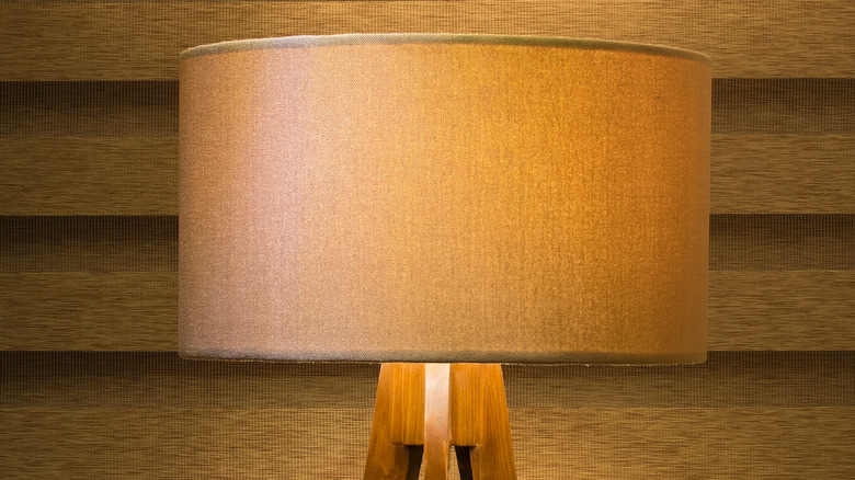 Beige drum lampshade on wooden lamp