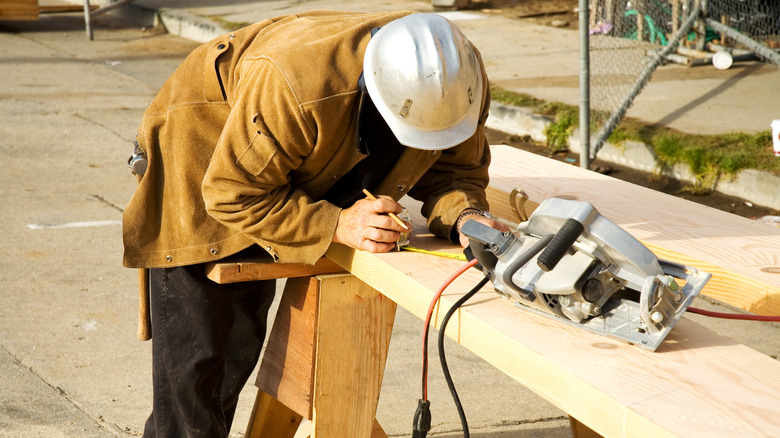 Man measuring stair stringers