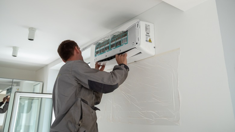 man installing air conditioner