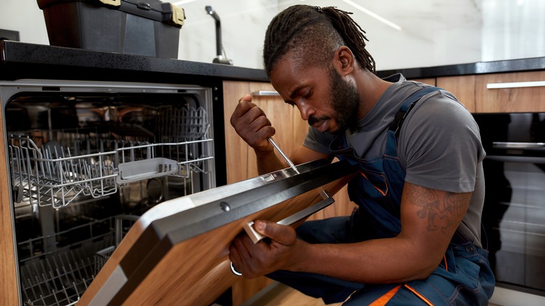 handyman setting up dishwasher