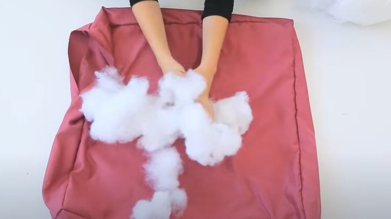 woman stuffing pillow