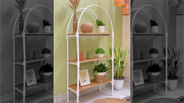 A free-standing PVC and wooden shelving unit with an arched top.