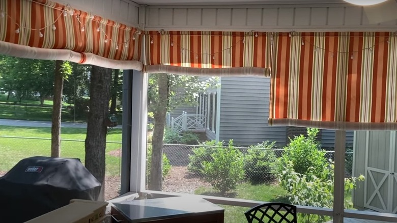 Patio surrounded by striped blinds