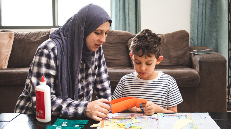 Woman and child doing paper crafts