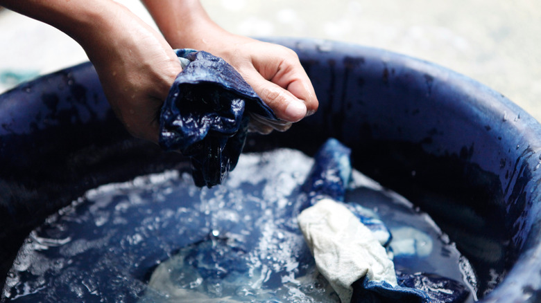 fabric being dyed in bucket