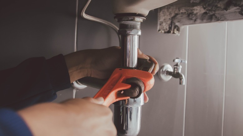 person doing plumbing work