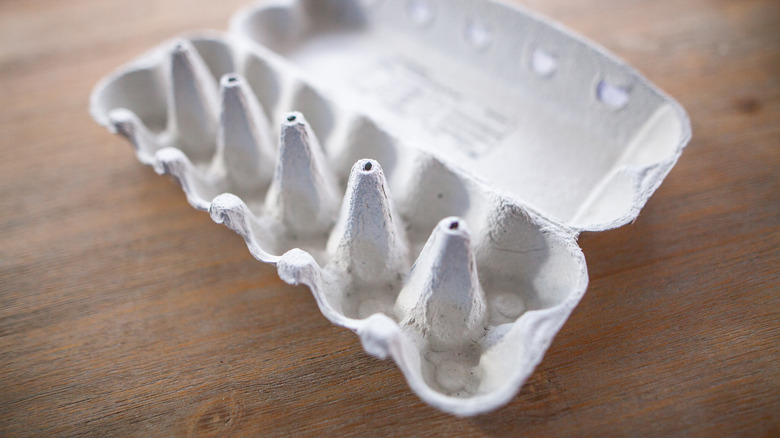 Open egg carton on surface