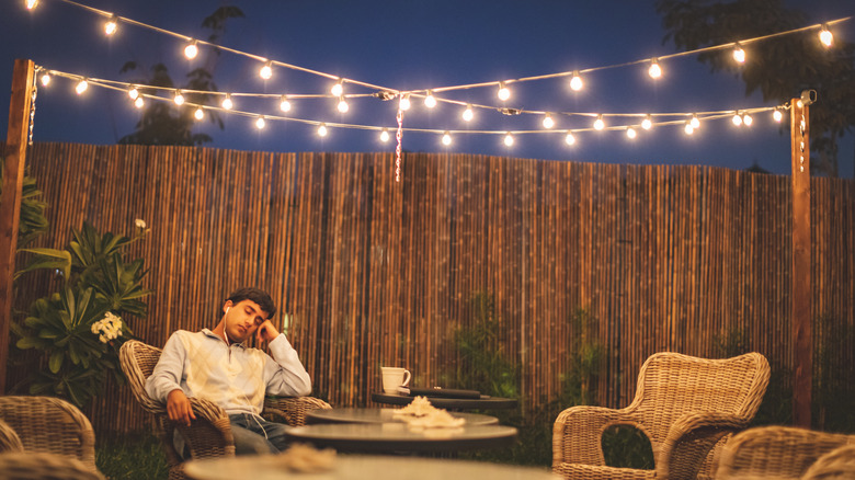 man sat outdoors patio 