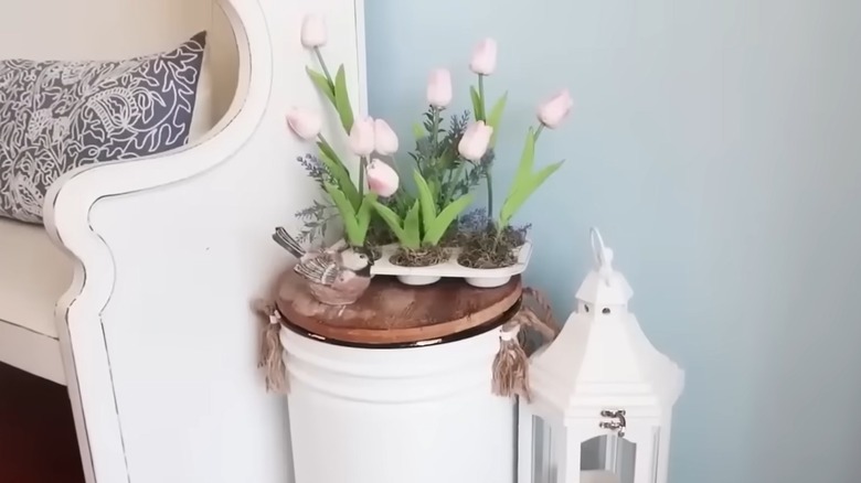 Faux pink tulips inside of decorated muffin tin