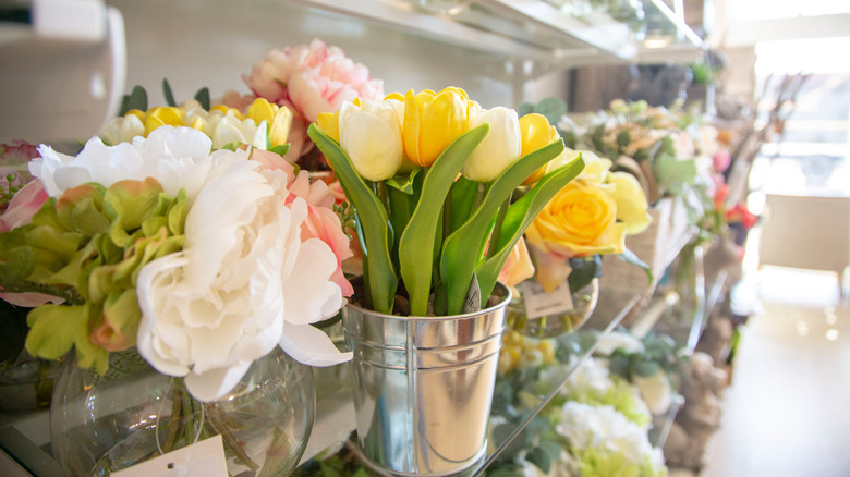 Faux flowers in store with camera focused on silk yellow tulips