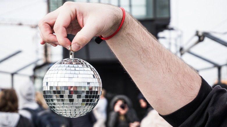 Hand holds mini disco ball