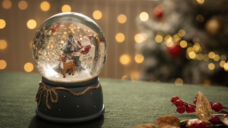 A Christmas-themed snow globe of Santa Claus and a reindeer