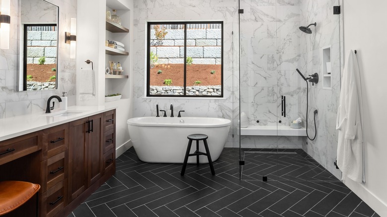 white marble bathroom with black slate tiles