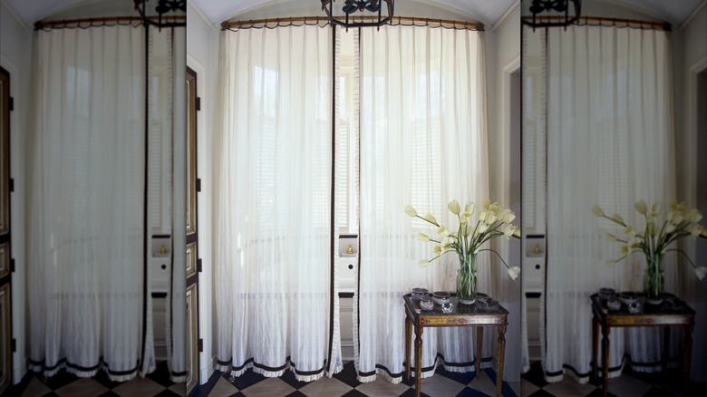 Floor to Ceiling shower curtains hung around a tub