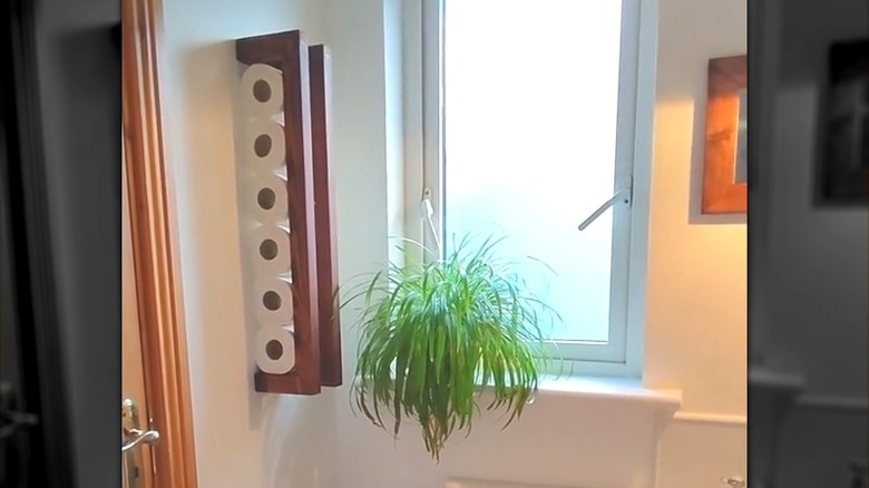 DIY scrap wood vertical wall-mounted toilet paper holder