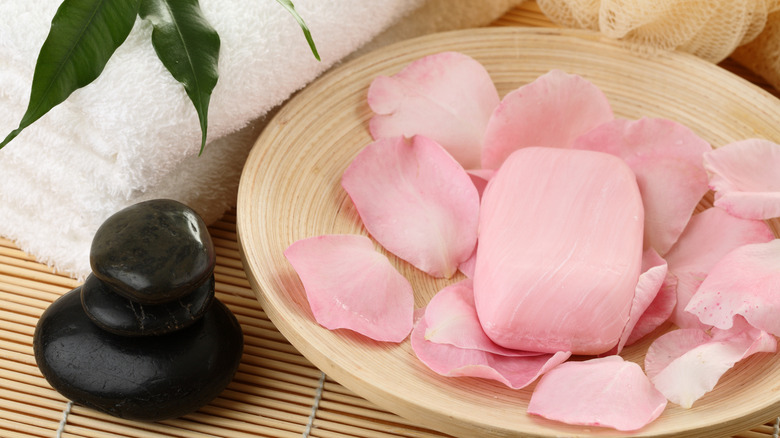 Pink rose petals in large wooden bowl