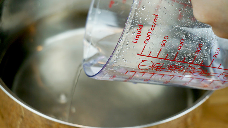 measuring cup pouring water