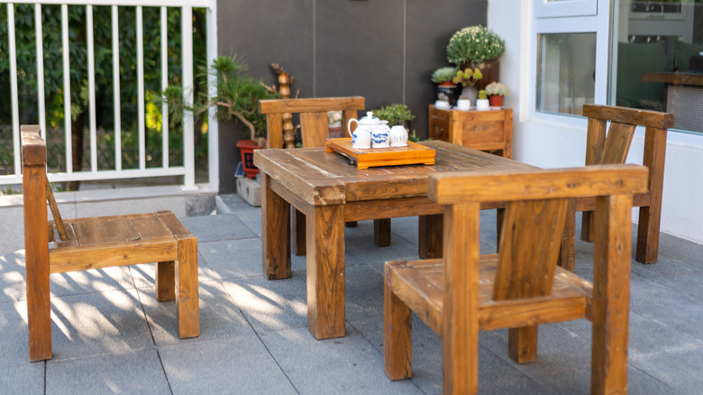 Wood chairs and table on a sunny patio