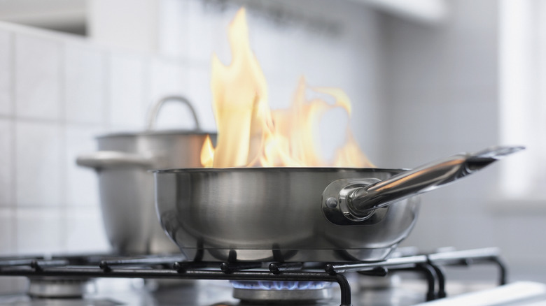 Flames coming out of stainless steel pan on stove