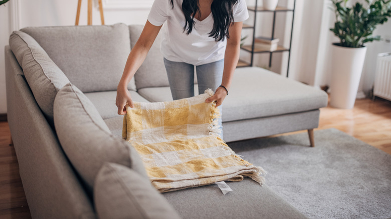 Woman rolling throw blanket