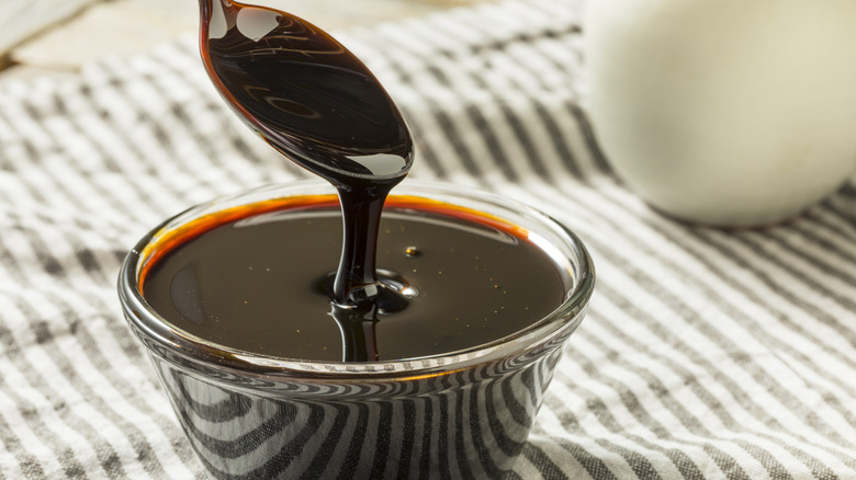 Spoon in bowl of molasses