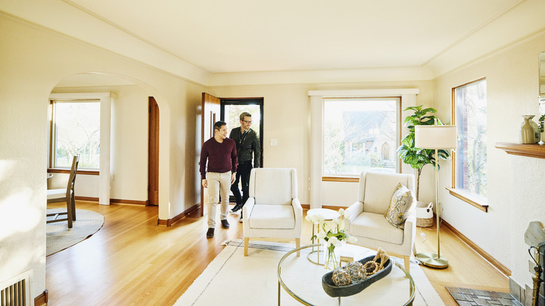 Two men walk into newly furnished home