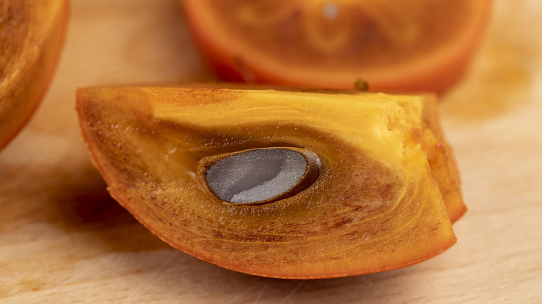 sliced persimmon with seed inside