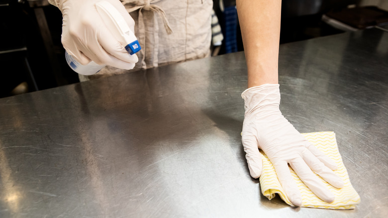 Wiping down stainless steel counter