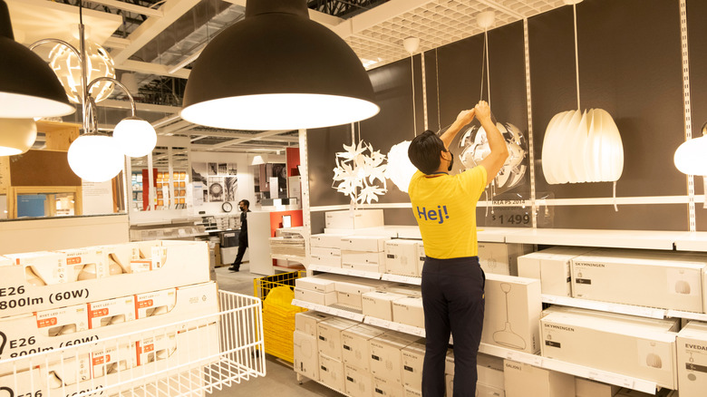 IKEA employee inside lighting section