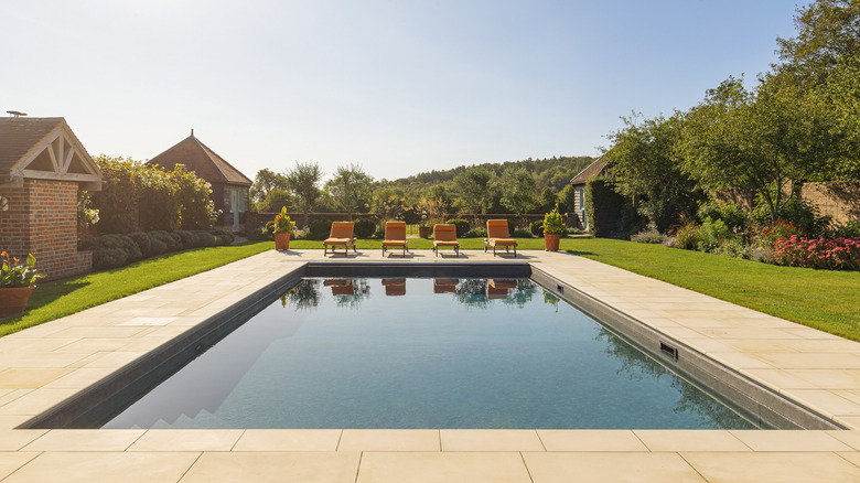 Backyard in-ground pool with chairs