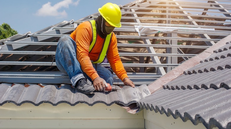 Roofer installing roof on home