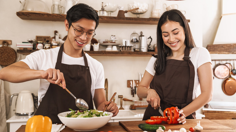 Young couple preparing salad