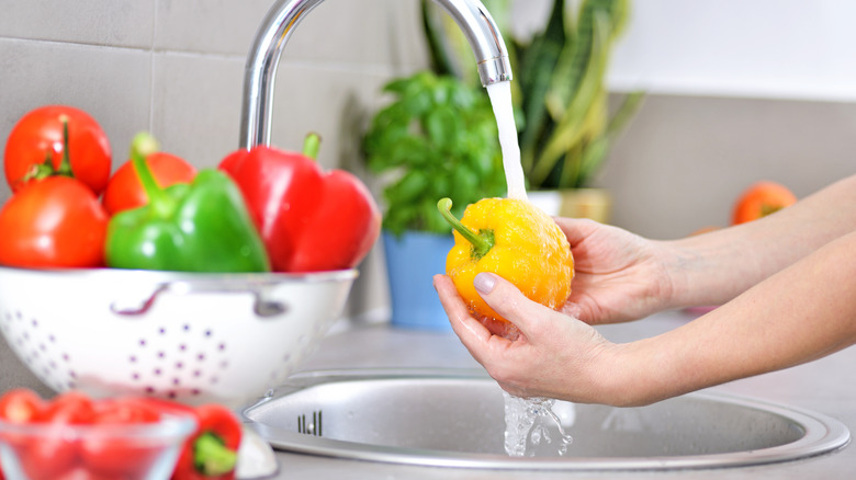 Washing vegetables in prep sink