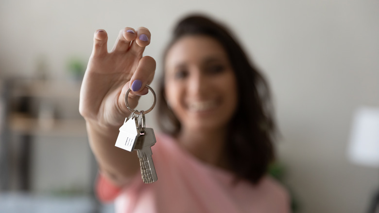 woman holding keys and smiling