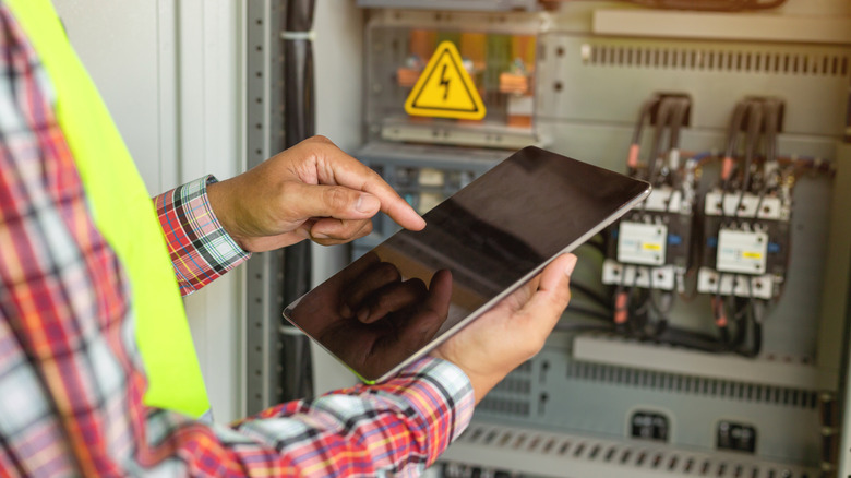 Person repairing electrical panel