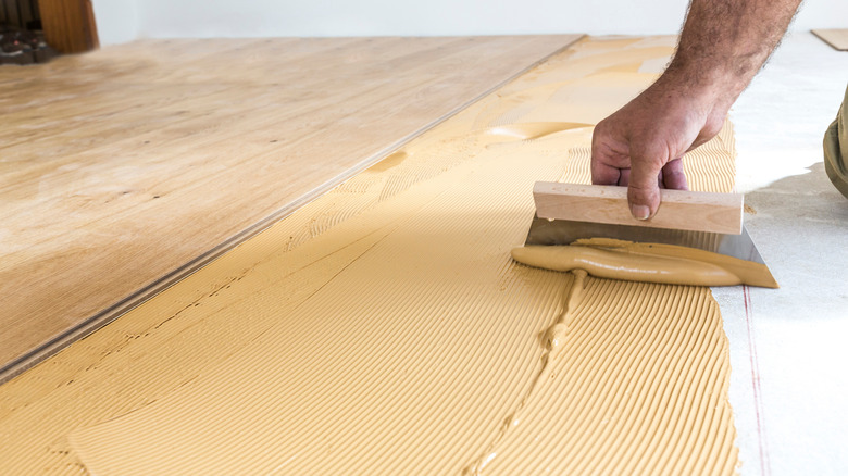 spreading hardwood floor adhesive