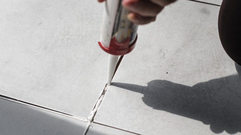 Caulking between floor tiles