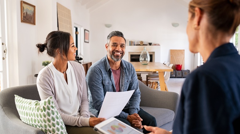 Couple discussing home with agent