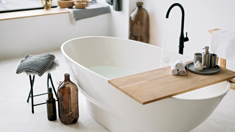 White bathtub with brown decor